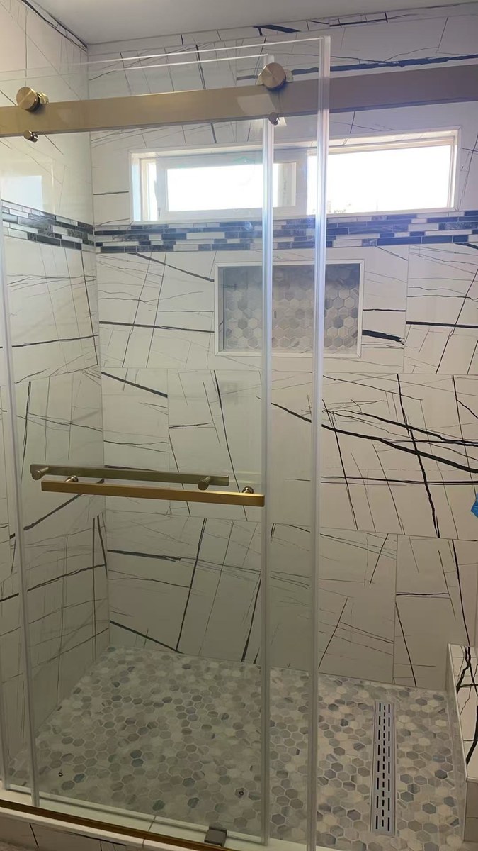 Walk-in shower remodel with tile and glass doors